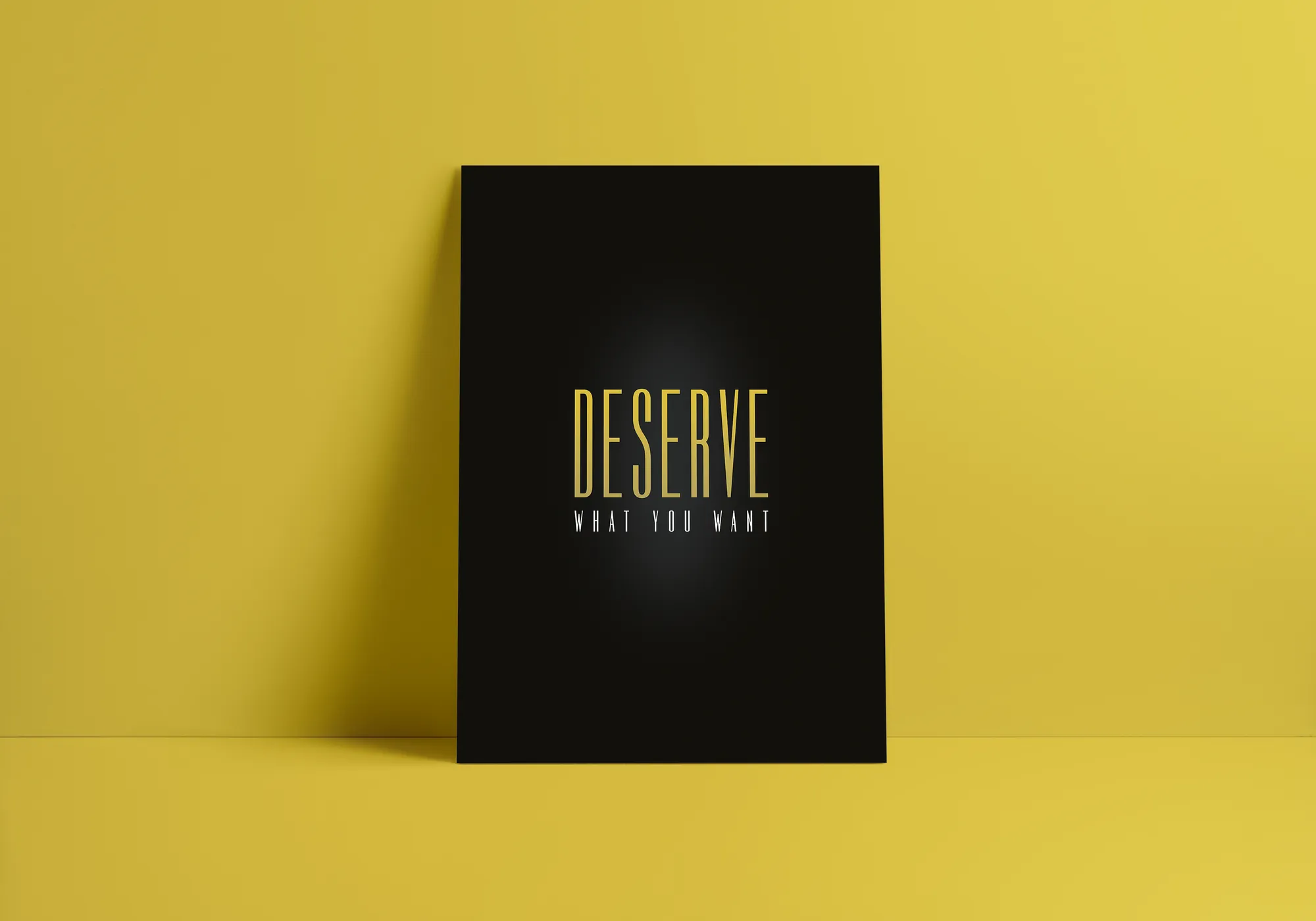 DESERVE WHAT YOU WANT poster in gold on black, against olive